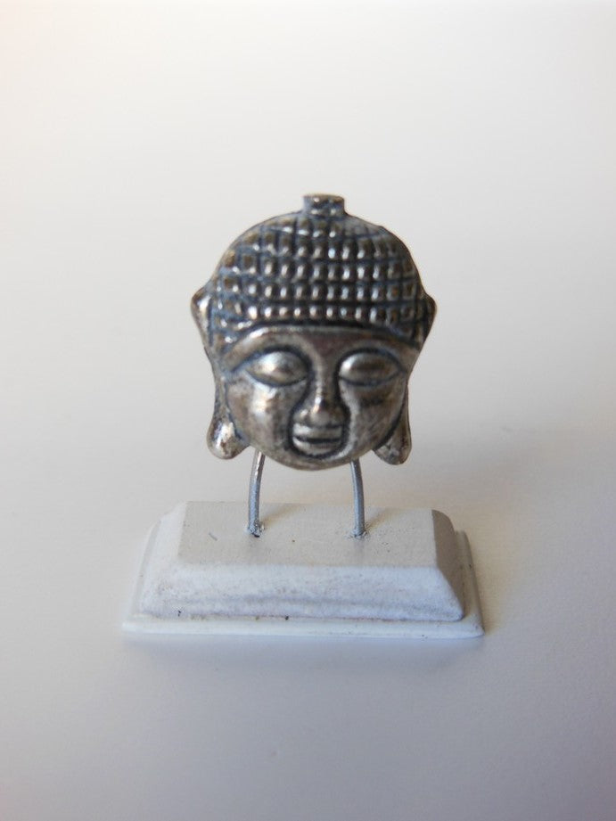 Small Silver Buddha Head on White Base