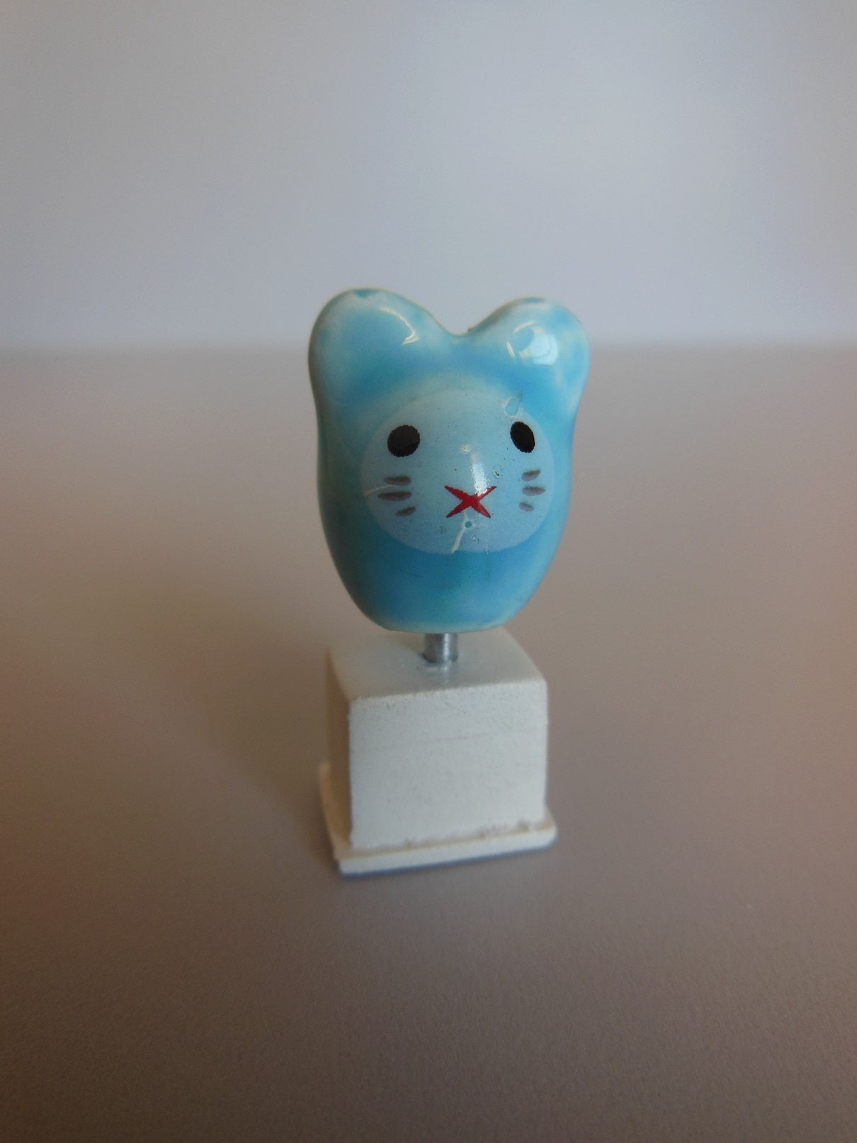 Cat Head Sculpture on White Base