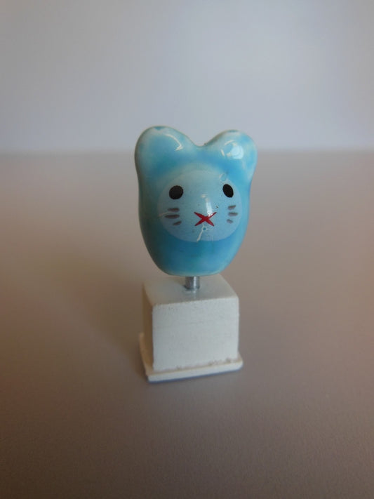 Cat Head Sculpture on White Base