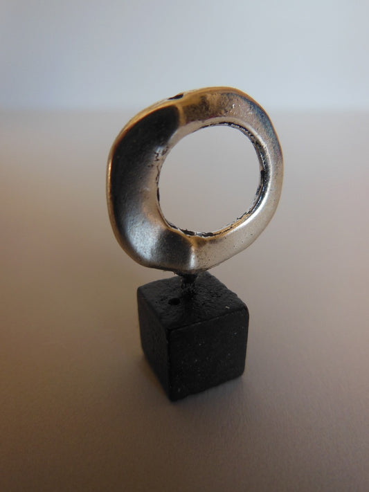 Silver Ring on Black Wood Base