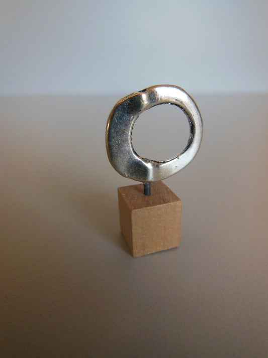 Silver Ring on Wood Base